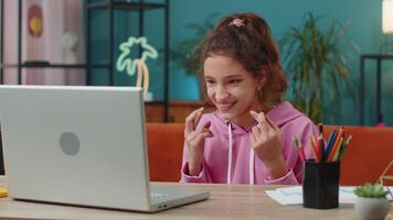 School girl using laptop celebrating victory at online lottery, successful passing of education exam video