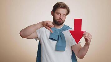 Upset young man showing red arrow pointing down, concept of downgrade bankruptcy money fail, fall video