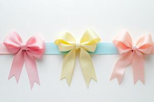 Three colorful ribbons with bows on white background for decoration and craft concept photo