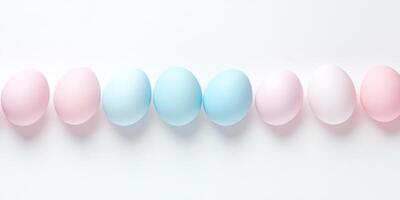 Pastel colored eggs in a row on white background highlighting easter theme photo