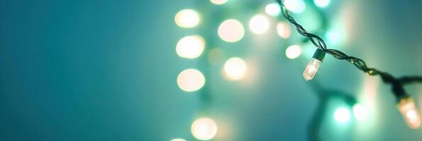 Blurred festive string lights creating a soft ambient glow with teal background photo