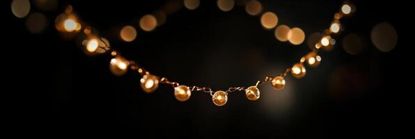 Festive string lights in focus against a dark blurred background for celebrations photo