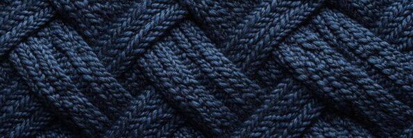 Blue knitted wool texture with interwoven pattern for background and textile design photo