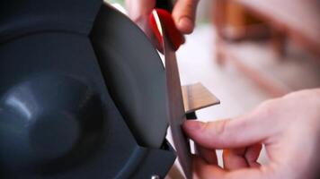 Close Up Male Hands Sharpening Knife In Street. Stock. Knife sharpening is the process of making a knife or similar tool sharp by grinding against a hard, rough surface. video