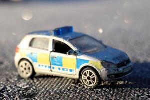 A diecast police car model on display, highlighting its realistic design amid colorful elements photo