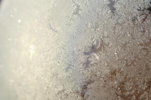 The Beautifully Intricate Frost Patterns Displayed on the Glass Surface in Detail photo
