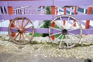 Rustic Wooden Wagon Wheels Decor Placed on a Charming Cobblestone Pathway for Aesthetic Appeal photo