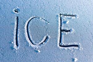 Beautiful Frosty Ice Patterns and Intricate Ice Lettering on a Cold and Chilly Surface photo