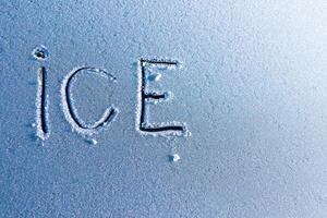 Frosty Surface Featuring Ice Letters An Artistic and Detailed Closeup Capture photo