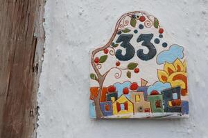 A Vibrant House Number Plate Featuring an Artistic and Eyecatching Design Element photo