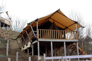 Experience the Stilted Glamping Tent nestled in a stunning Natural Setting for your getaway photo