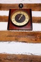 A beautiful Vintage Clock displayed on a Rustic Wooden Wall adds character and charm to any space photo