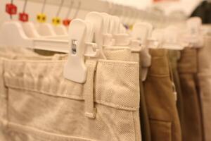 A modern and stylish pants rack display featured in a trendy fashion store setting photo