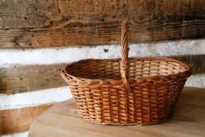 A Handcrafted Wicker Basket Sitting Elegantly on a Wooden Surface in a Rustic Setting photo