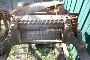 A Rusty Vintage Machinery Component Featuring Intricate Gears and Rollers That Stand Out photo