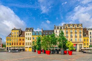 Lille cityscape, La Grand Place square General de Gaulle, historical monument Flemish mannerist architecture style, row of buildings, trees in pots, Nord department, Hauts-de-France Region, France photo
