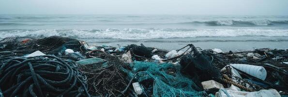 Ocean pollution with piles of plastic and fishing nets on seashore photo
