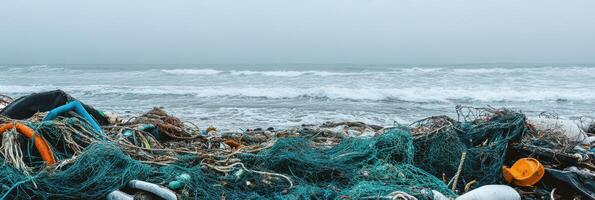 Ocean pollution with abandoned fishing nets and marine debris on beach shoreline photo