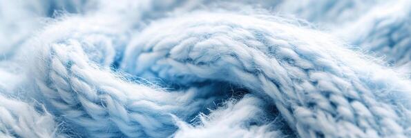 Soft blue knitted wool yarn close-up texture in abstract twist pattern photo