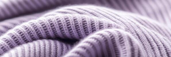 Close-up of lilac knitted fabric with ribbed texture in soft focus photo