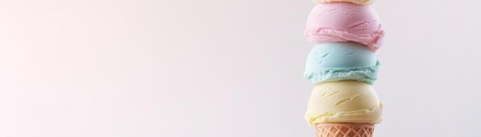 A vibrant tower of 3D ice cream scoops in shades of red, orange, yellow, green, blue, and purple is perfectly stacked on a waffle cone. The clean background offers ample space for text photo