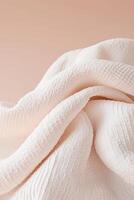 A soft glowing quilt is draped over a surface, showcasing comforting textures designed to evoke relaxation and stress relief against a neutral gradient background photo