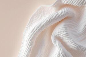 A soft, glowing quilt is gracefully draped over a smooth surface, showcasing textures that evoke comfort. The neutral gradient background enhances its serene appearance photo
