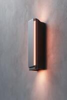 A modern infrared heater is securely mounted on the wall, radiating a warm red-orange glow. The clean, neutral background enhances its sleek design, providing space for text or branding photo