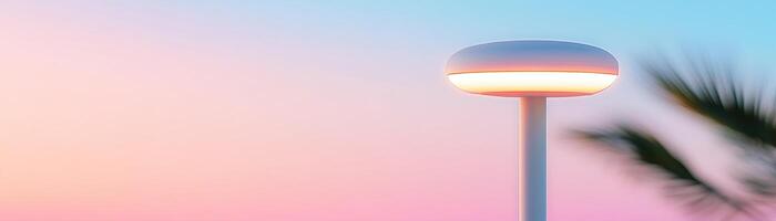 A sleek outdoor patio heater emits a warm glow under a gradient twilight sky. Surrounded by gentle shadows and hints of greenery, it provides both functionality and modern style photo