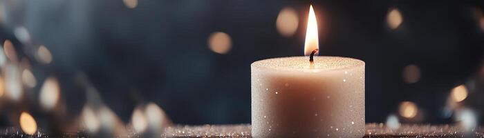 A tranquil setting features a glowing candle with a subtle flame, surrounded by soft, glowing particles. The dark background enhances the serene atmosphere, ideal for branding or text overlay photo