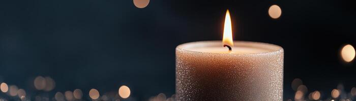 A glowing candle with a delicate flame is surrounded by soft, shimmering particles in a dark background, offering a tranquil and peaceful atmosphere for meditation and reflection photo