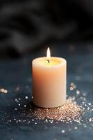 A glowing candle with a subtle flame stands alone against a dark backdrop. Soft, glowing particles surround it, creating a calm ambiance, ideal for text overlays and branding opportunities photo