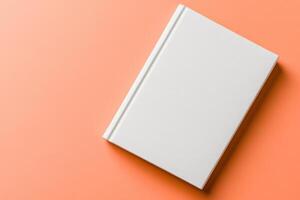 Elegant mockup of a blank white book cover displayed on a soft peach background to highlight its clean design and versatility in presentation photo