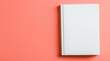 Elegant blank white book cover mockup against a soft peach background highlighting minimalistic design for classic presentation and versatility photo