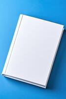 Minimalist mockup of a book with blank cover against a smooth gradient blue background for design purposes photo