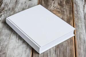 Minimalist mockup featuring a book with a blank cover on a rustic wooden surface for design inspiration and creativity photo