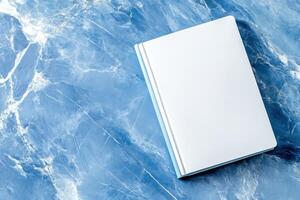 Minimalist book design mockup on marble pattern surface showcasing blank white cover for branding purposes photo