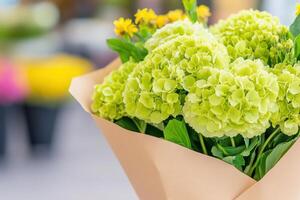 Bright and cheerful bouquet featuring green hydrangeas and wild yellow flowers, perfect for any celebration or gift occasion photo