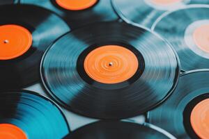 Vintage vinyl records with brown covers and orange labels arranged on a modern gray table creating a retro atmosphere photo
