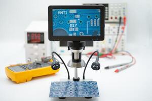 Electronics workstation for inspecting circuit boards with digital display and testing equipment photo