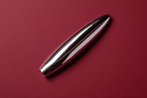 Sleek metallic object on a red background photo