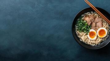 Delicious ramen noodles with pork, egg, and green onions photo