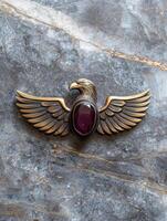 Ornate eagle brooch with purple gemstone photo