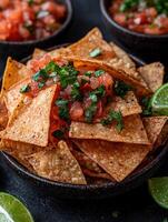 Spicy tortilla chips with salsa and cilantro photo