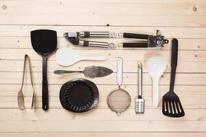 cookware and accessories on a wooden table. photo