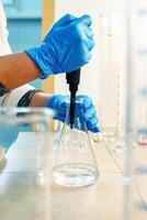 Experimenting with liquid manipulation in a laboratory setting during daylight hours photo