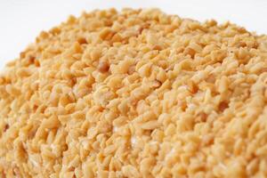 Delicious sesame-coated treat with a golden brown hue displayed against a white background photo