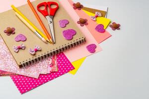 Crafting materials on a table showcasing colorful paper, scissors, and decorative embellishments for creative projects photo