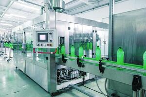 Bottle filling machine operates in a clean beverage production facility during daylight hours photo