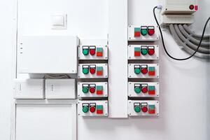 Control panel with multiple switches and indicators installed on the wall in a modern industrial setting photo